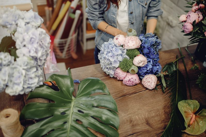 Girl with a flowers. Florist making a bouquet